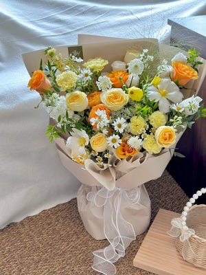 Bouquet of flowers with white, yellow, and orange colors on a neutral background