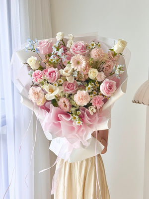 Luxury fresh flower bouquet with pink gerbera, blush roses, white tulips, and eustoma wrapped in elegant pastel packaging for same day delivery KL.