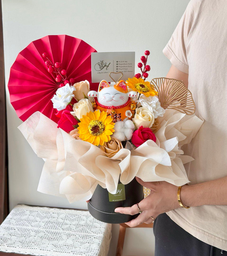 Lucky cat (Maneki Neko) business opening flower arrangement with soap flowers, sunflowers and roses in elegant box, symbolising prosperity and good fortune for grand opening celebrations by a florist in Malaysia.