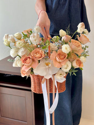 Floral basket filled with cappuccino roses and white accents, beautifully styled for celebrations, new beginnings, or everyday joy.