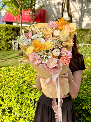 Colorful flower bouquet with daisy-like chamomile flowers and a variety of fresh seasonal florals.