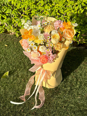 Woman holding a cheerful bouquet filled with warm-toned roses, carnations, and playful daisies.