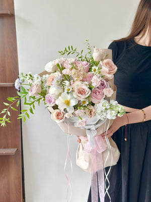 Luxury pink, white and quicksand rose floral arrangement wrapped with soft ribbons for gift or birthday gift.