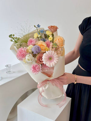 A girl dressed in black presents a colorful bouquet of flowers, honoring her mother on Mother's Day 2025.