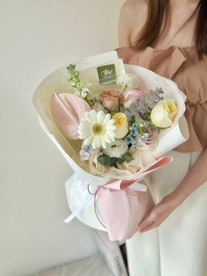 A girl wearing a brown shirt presents a gerbera bouquet for her friend's birthday celebration in Kuala Lumpur.