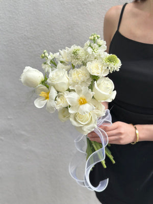 1. A woman in a wedding dress holds a bouquet of white flowers, symbolizing love and celebration.
2. A bride holds a bouquet of white flowers, representing purity and joy on her wedding day.
3. A woman in a wedding gown proudly displays a bouquet of white flowers, embodying elegance and romance.
