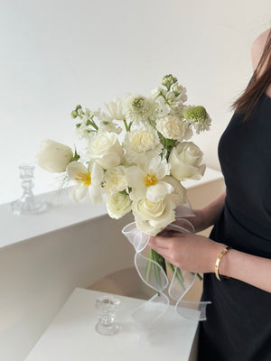1. A woman in a wedding dress holds a bouquet of white flowers, symbolizing love and celebration.
2. A bride holds a bouquet of white flowers, representing purity and joy on her wedding day.
3. A woman in a wedding gown proudly displays a bouquet of white flowers, embodying elegance and romance.