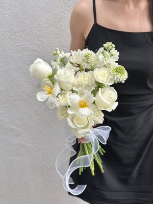 1. A woman in a wedding dress holds a bouquet of white flowers, symbolizing love and celebration.
2. A bride holds a bouquet of white flowers, representing purity and joy on her wedding day.
3. A woman in a wedding gown proudly displays a bouquet of white flowers, embodying elegance and romance.