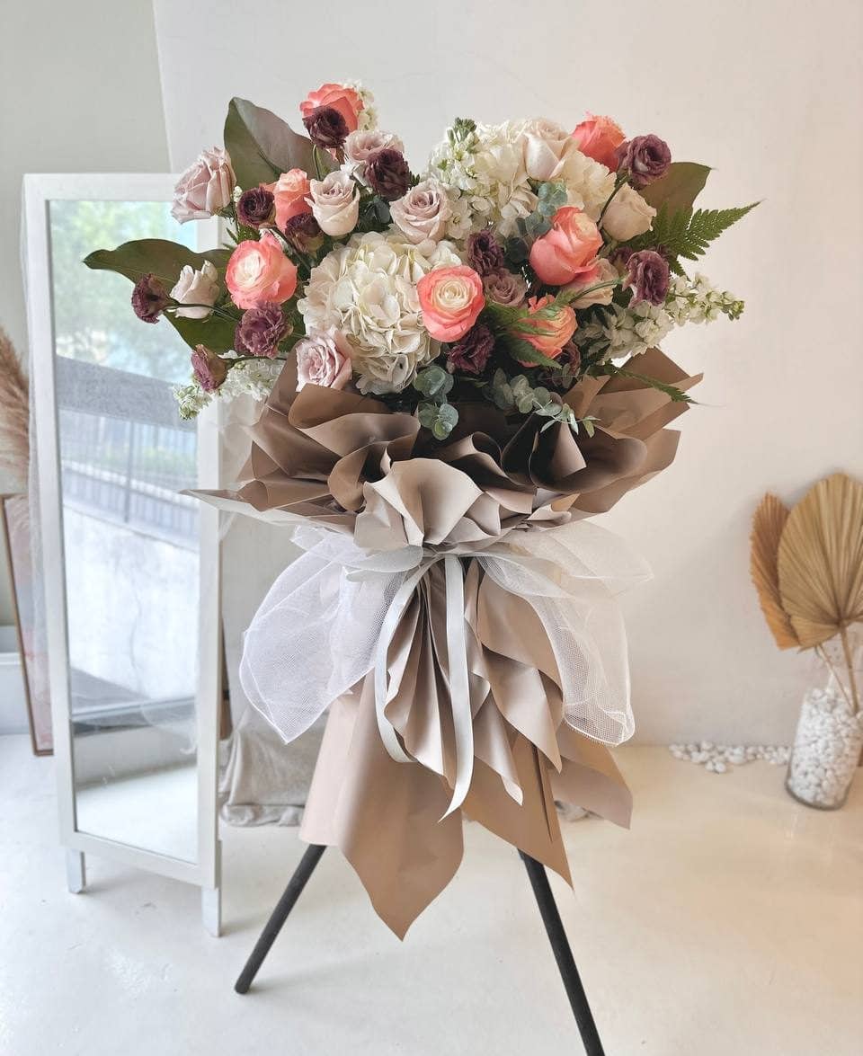 A Business Flower stand is placing in front of a mirror at a business open ceremony at Kuala Lumpur.