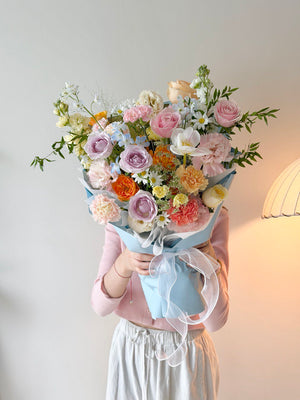 Elegant pastel flower bouquet featuring pink roses, lilac roses, carnations and daisies perfect for any occassions.