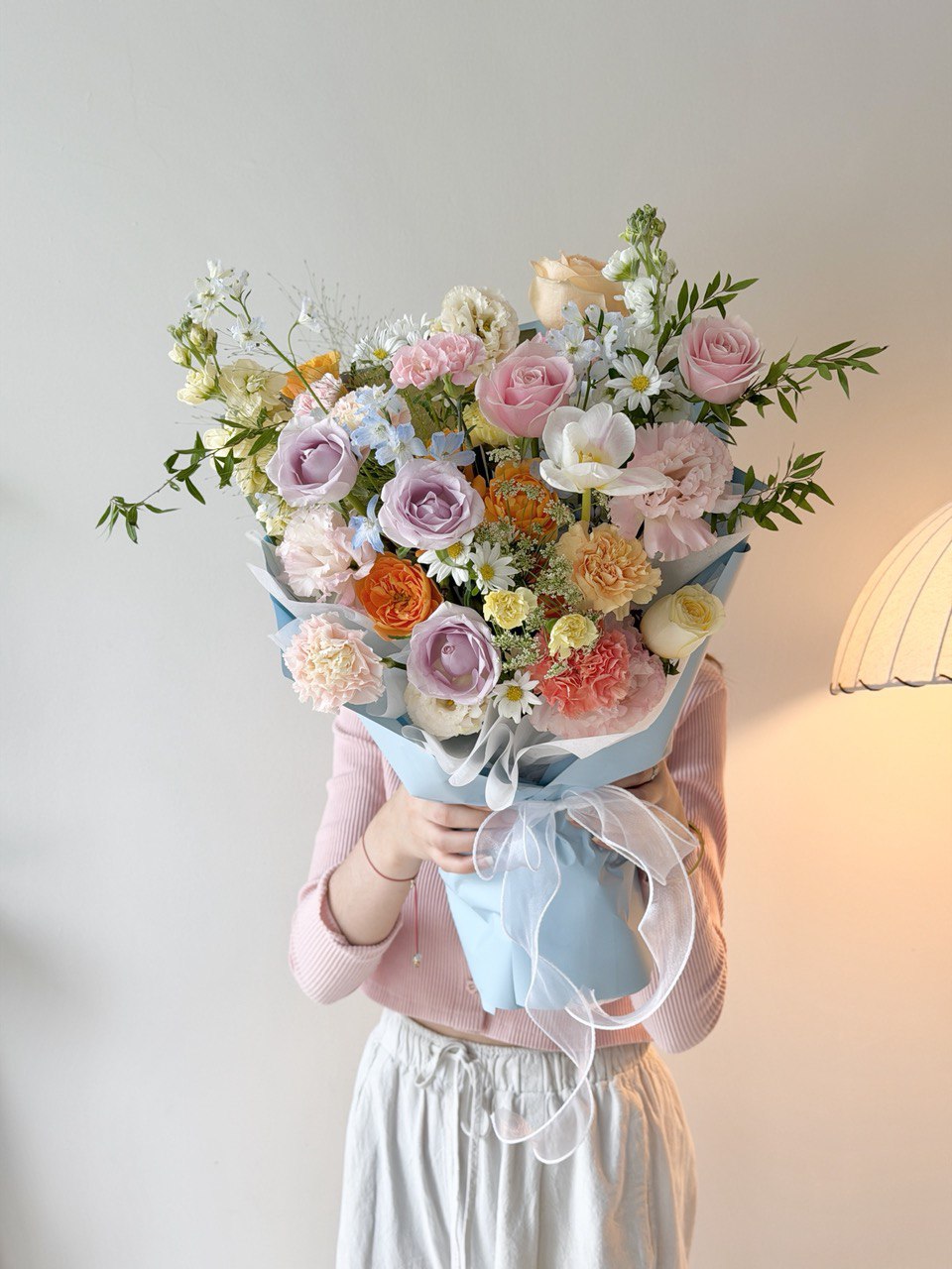 Elegant pastel flower bouquet featuring pink roses, lilac roses, carnations and daisies perfect for any occassions.