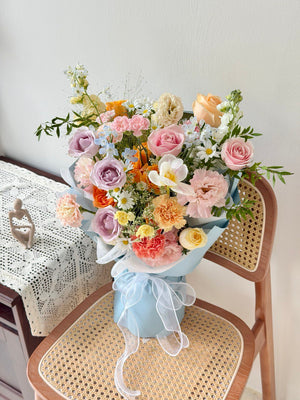 Soft pastel mixed bouquet with pink, champagne roses and lilac roses for birthdays and anniversaries.