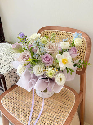 Pastel flower box with lilac roses and white blooms, perfect for housewarming or anniversary gifting.