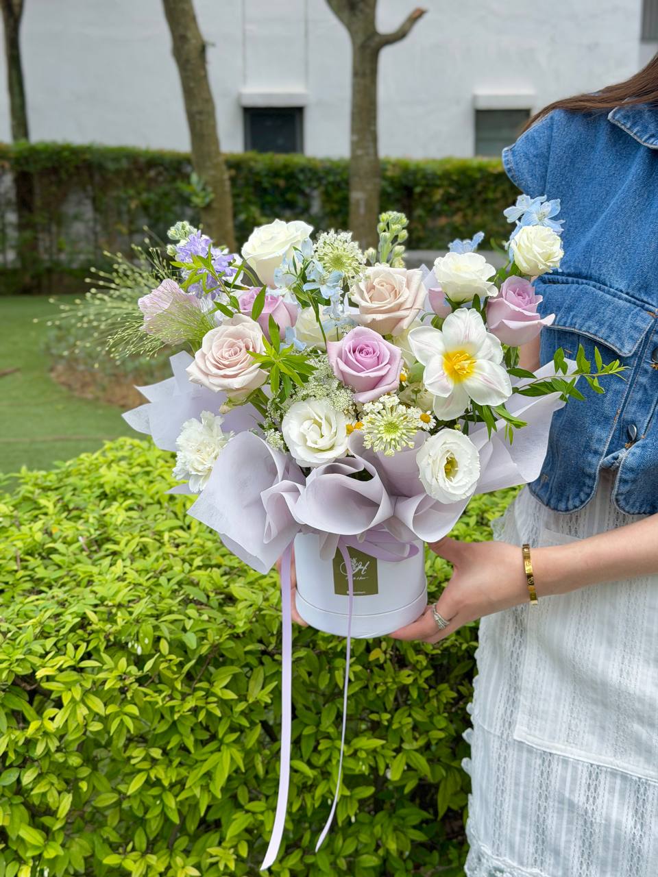 Soft pastel mixed flower box with roses and tulip-style blooms for birthday or housewarming occasions.