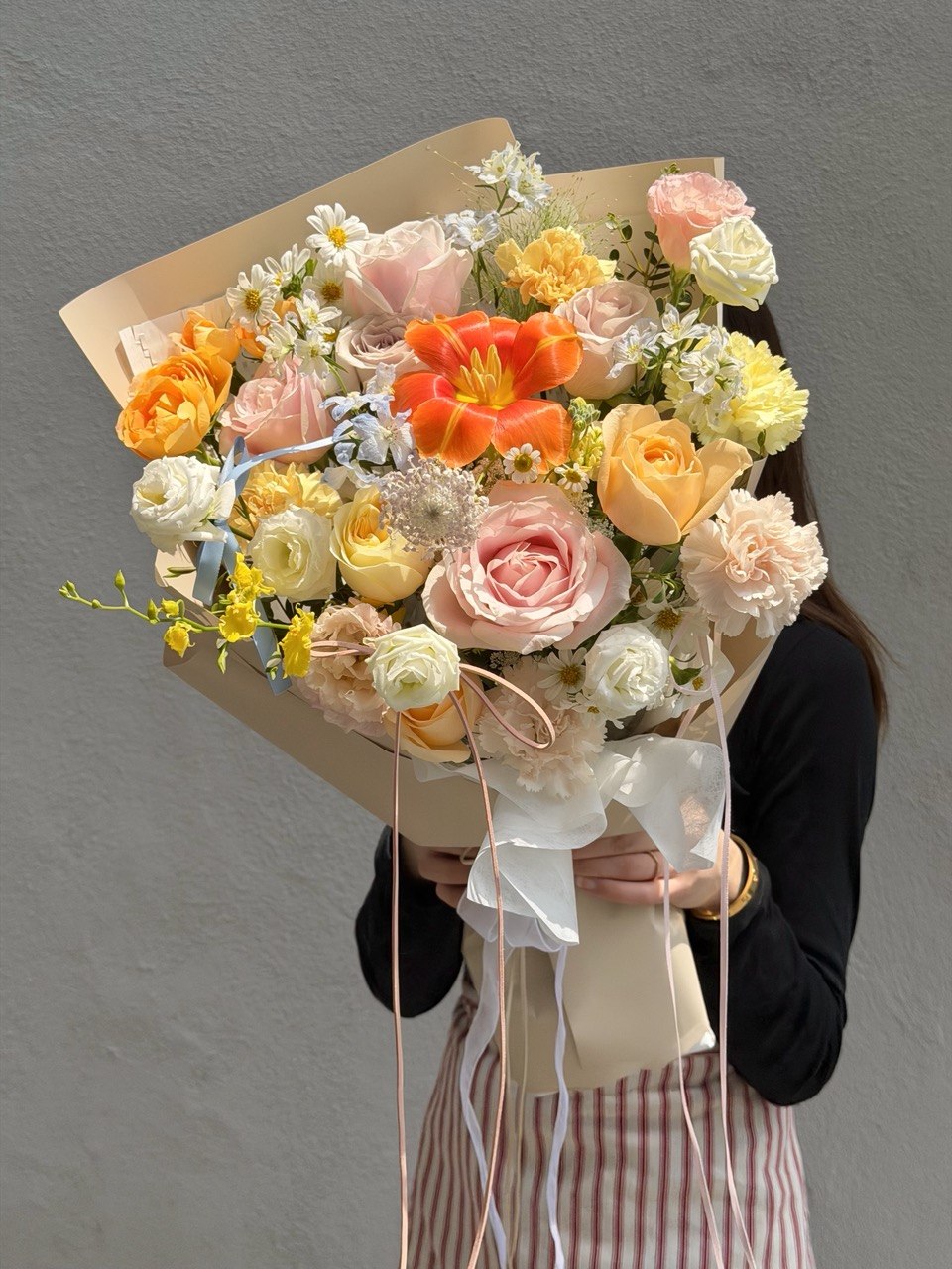 Elegant orange tulip flower bouquet with soft pink roses, buttercup roses, carnations and blue delphinium, perfect for birthday surprise, anniversary gift and same day flower delivery in Kuala Lumpur and Selangor.
