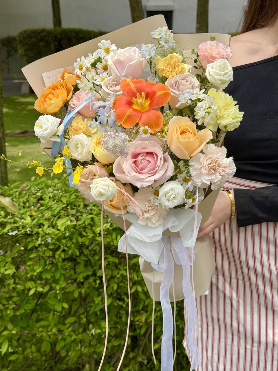 Premium pastel flower bouquet featuring vibrant orange tulip, blush pink roses, cream buttercup roses, carnations and delphinium blue flowers for birthdays, anniversaries and just because moments in KL and Selangor.