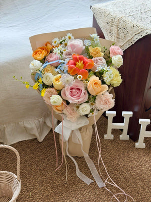 Romantic mixed flower bouquet with orange tulip, pink roses, carnations and delicate blue oxypetalum, beautifully wrapped for same day flower delivery across Kuala Lumpur and Selangor.