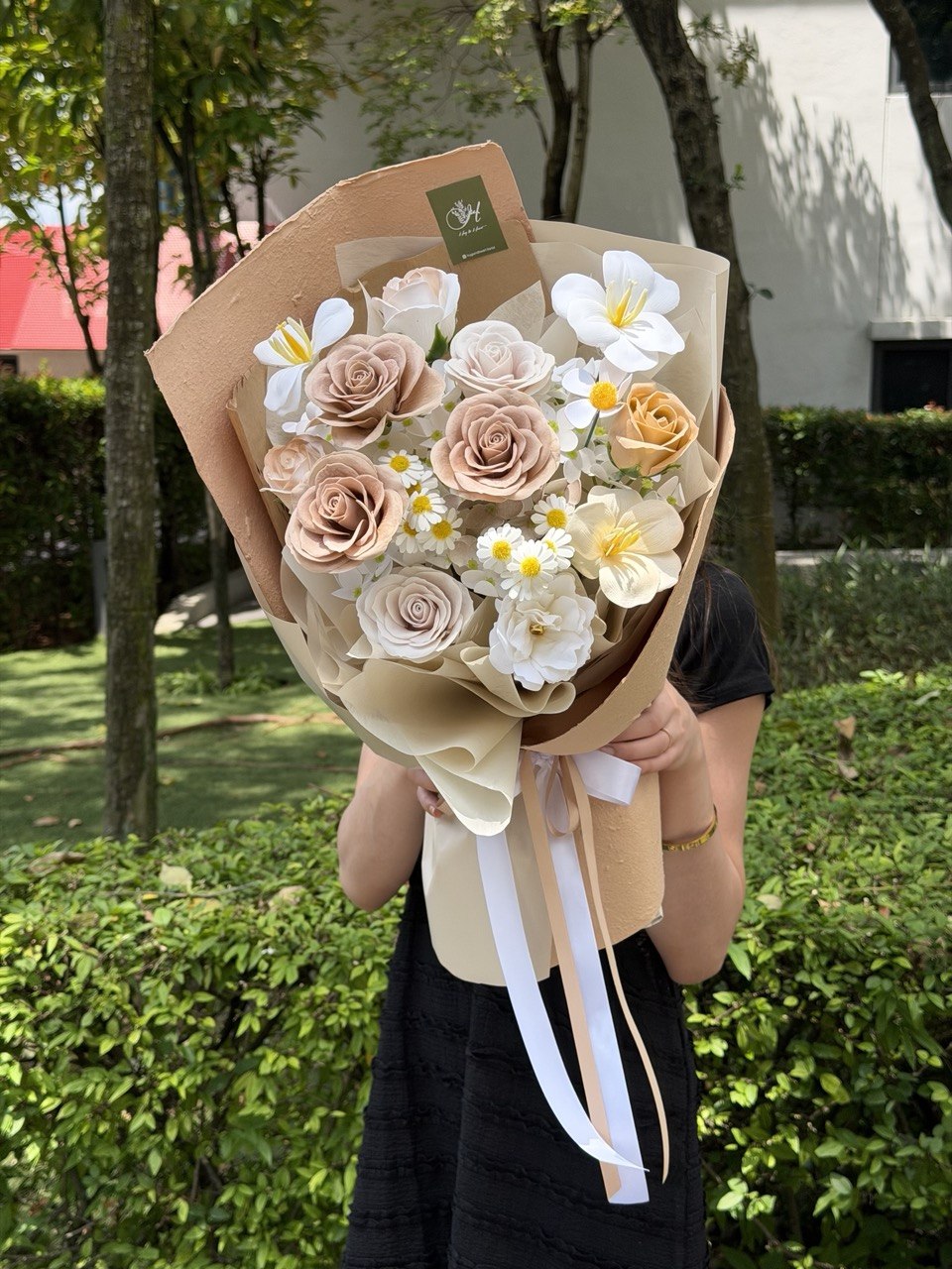 Luxury soap flower bouquet in neutral cream tones with artificial roses and plumeria flowers for everlasting floral gift.