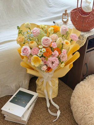 Elegant yellow wrapping flower bouquet with pastel mixed roses and soft pink flowers, suitable for birthday and anniversary gifts - same day flower delivery Kuala Lumpur and Selangor.