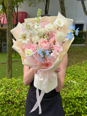 Elegant pastel flower bouquet featuring pink roses, white gerbera, carnations, and blue delphinium flowers with same day flower delivery in Kuala Lumpur and Selangor.