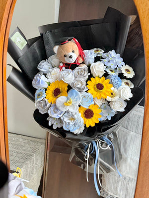 A bouquet of graduation soap flower with brown graduation bear is held by a girl ideally for graduation at Kuala Lumpur and Selangor with same day delivery.