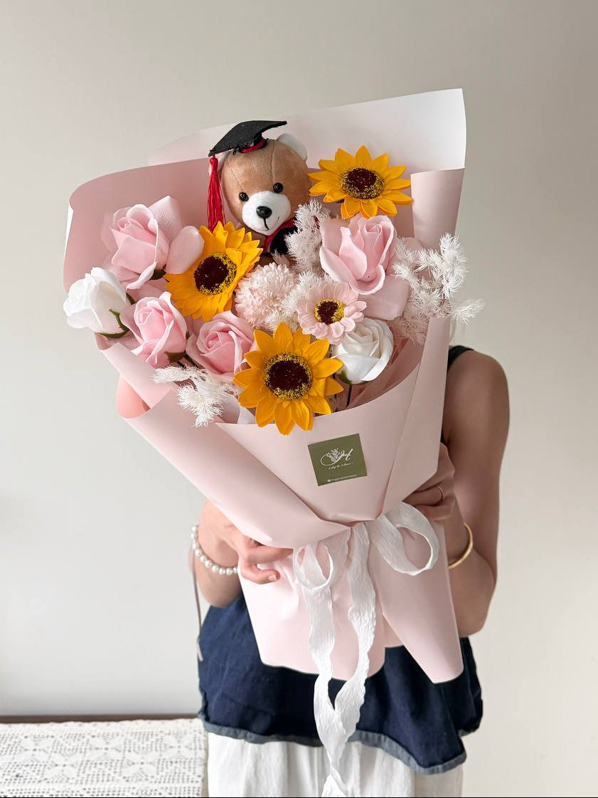 A graduation bouquet featured soap flower with brown graduation bear perfect gift for University graduation at Malaysia.