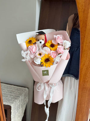 A graduation bouquet featured soap flower with brown graduation bear perfect gift for University graduation at Malaysia.