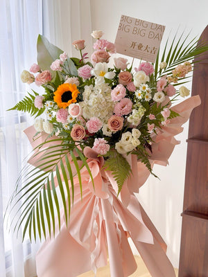 Luxury grand opening flower stand featuring sunflower, white hydrangea, pink roses and elegant tropical foliage. Large congratulatory flower stand with same day delivery in KL, Petaling Jaya, Shah Alam and Selangor by Hug and Heart Florist.