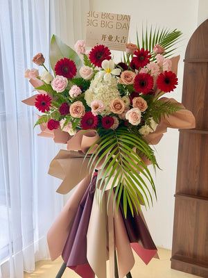 Premium grand opening flower stand prepared by Hug and Heart Florist with fresh red gerberas, roses, hydrangea and tropical foliage. Large floral arrangement with same day delivery throughout Kuala Lumpur and Selangor.