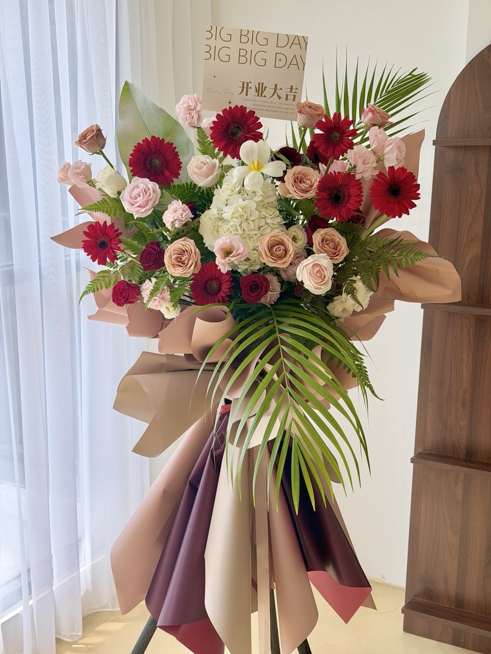 Premium grand opening flower stand prepared by Hug and Heart Florist with fresh red gerberas, roses, hydrangea and tropical foliage. Large floral arrangement with same day delivery throughout Kuala Lumpur and Selangor.
