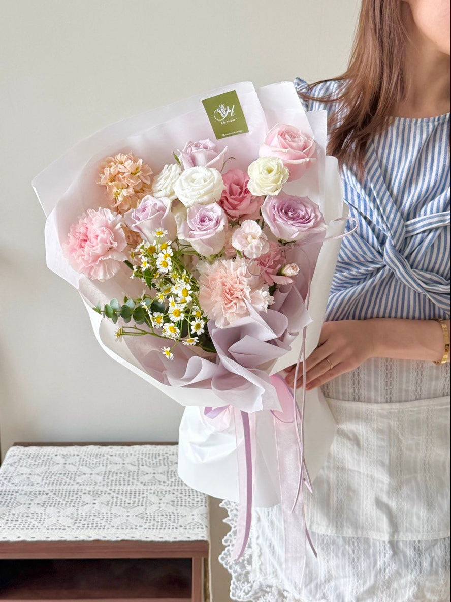 A girl wearing blue top holding a bouquet of lilac rose, pink rose and nude carnation, same day delivery flower at Kuala Lumpur and Selangor.