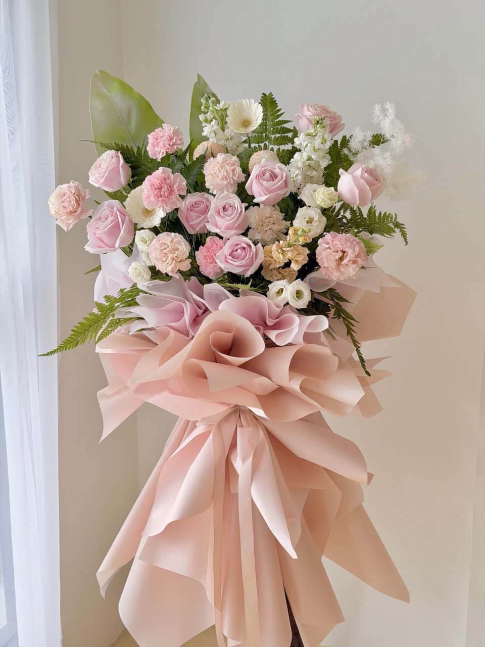 A business opening flower stand with pastel pink colour theme, prepared by Hug and Heart Florist at Sunway Geo Avenue - perfect for business opening gift across Kuala Lumpur and Selangor.
