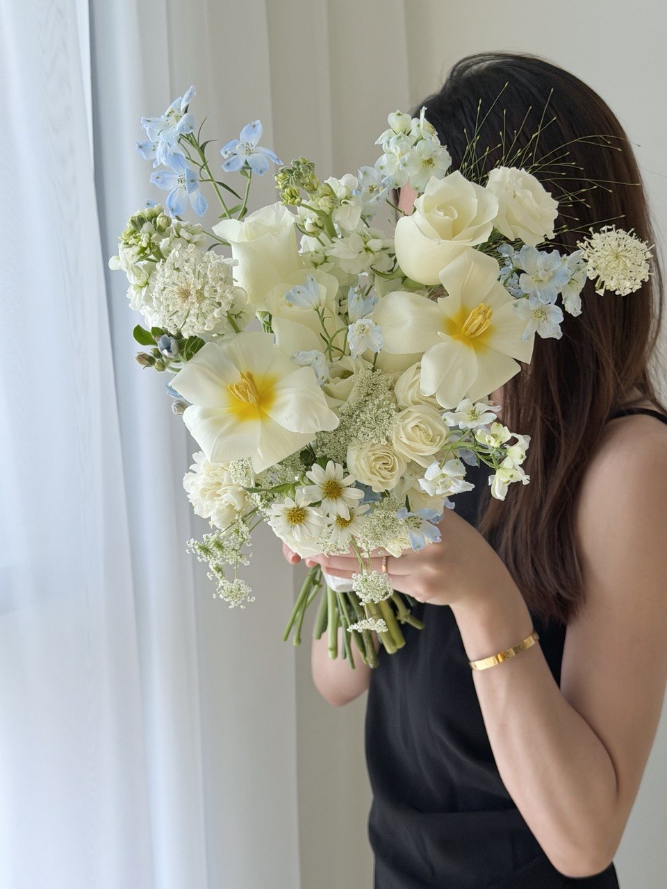 Romantic white and blue bridal bouquet with tulips, white roses, delphinium blue and oxypetalum blooms, ideal for wedding solemnization and ROM in Kuala Lumpur.