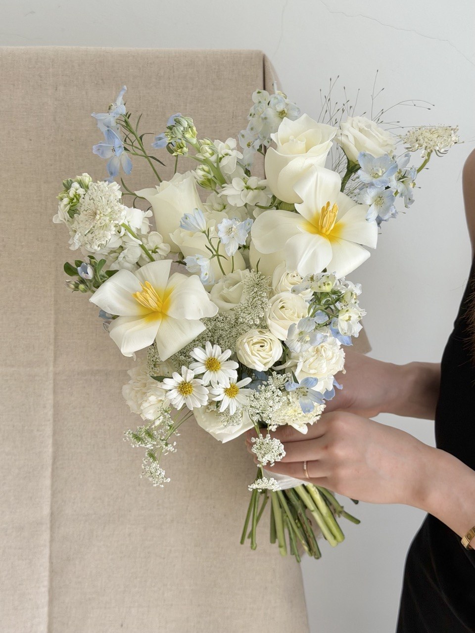 Modern minimalist ROM bouquet crafted with white tulips, white roses, blue delphinium and oxypetalum flowers, elegant wedding flower delivery service in KL and Selangor.