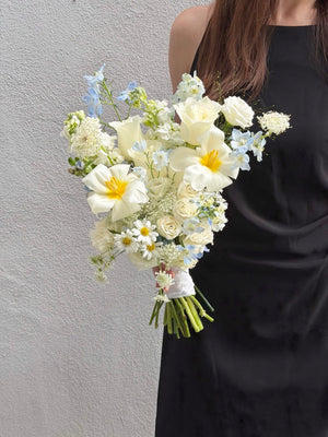 Luxury ROM bouquet featuring white tulips, premium white roses, blue delphinium and oxypetalum flowers, handcrafted for weddings with same day flower delivery KL and Selangor.