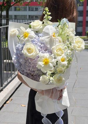 Pastel purple hydrangea bouquet with white rose, tulip and Phalaenopsis orchid.