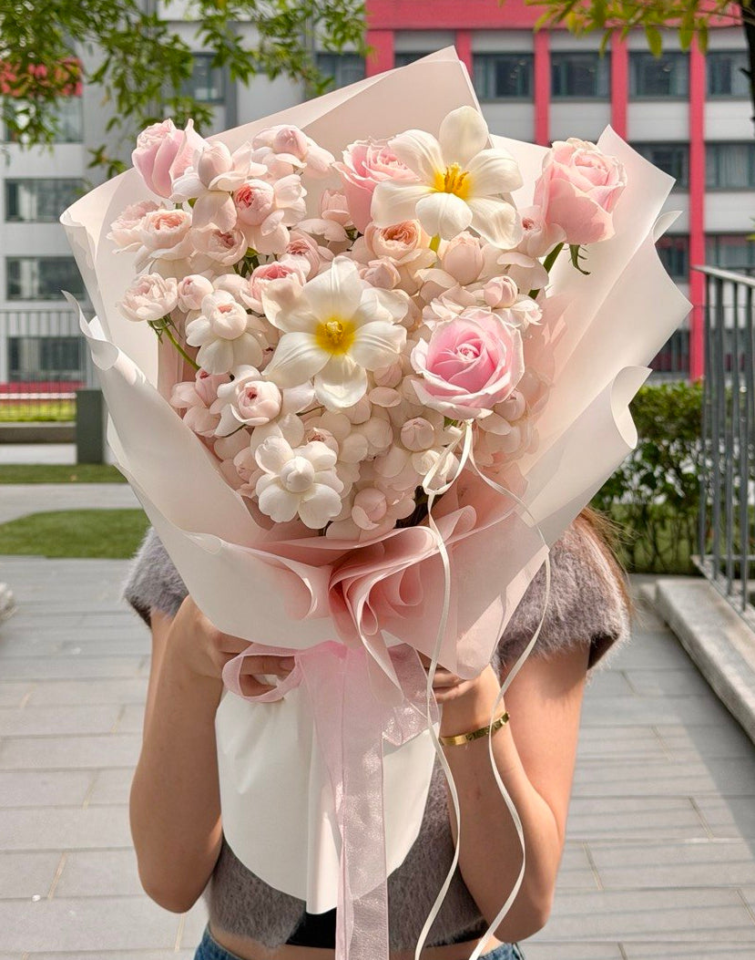 Pink Kiss of Fairy rose bouquet with delicate flowers for birthday celebration.