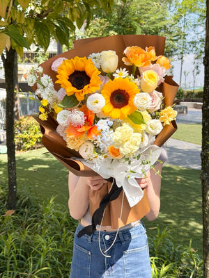 Person holding a large bouquet of sunflower outdoor, perfect flower for graduation, congratulation flowers. 