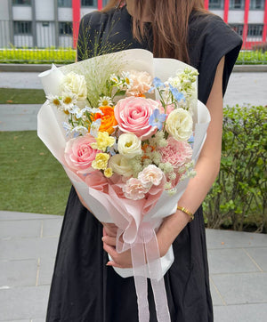 Elegant small bouquet with pink roses, blue delphinium, white blooms, and delicate mixed fillers, beautifully wrapped for birthdays, anniversaries, and same-day flower delivery across KL and Selangor.