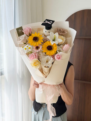 A girl is holding a bouquet of graduation soap flower for her graduation at Sunway University Subang Jaya.