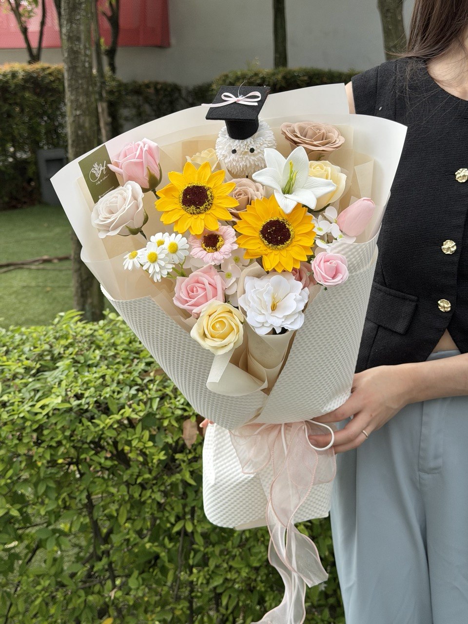 A girl is holding a bouquet of graduation soap flower for her graduation at IMU Graduation Bukit Jalil.