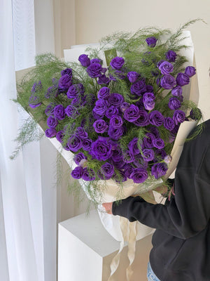A bouquet of purple Eustoma wrapped in white wrapper ideally for birthday or anniversaries celebration at Kuala Lumpur.