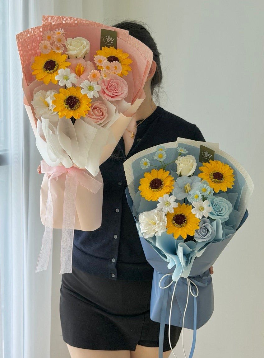 Sunflower Soap Flower bouquet with pink roses, white daisies, and peach wrapping for Graduation at Sunway University.