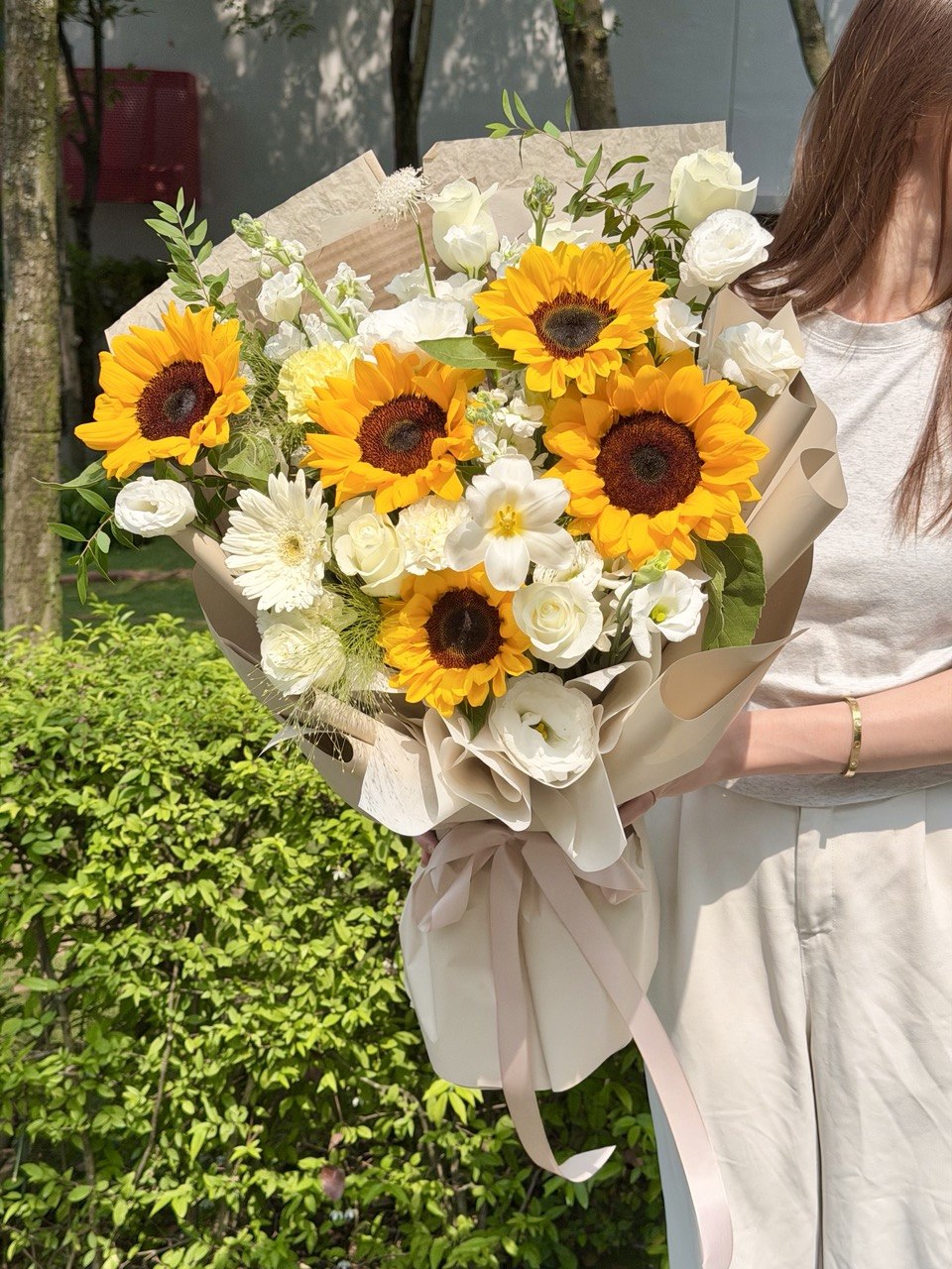 Sunflower graduation bouquet with white roses and elegant beige wrapping for graduation flower delivery in KL and Selangor.