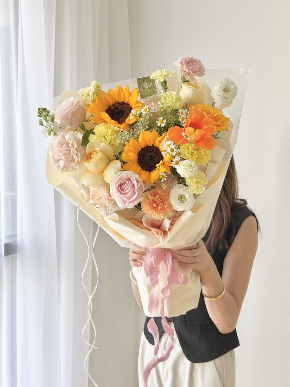 Graduation celebration bouquet with sunflower and pastel mixed flowers including orange tulip and pink roses, same day delivery by Hug and Heart Florist Subang Jaya.
