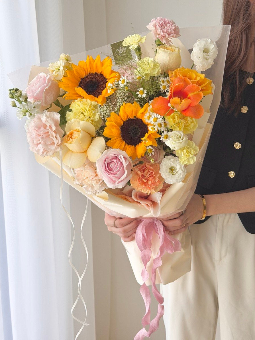 Soft pastel graduation flower bouquet with sunflower, orange tulip, buttercup roses and pink roses, same day delivery Kuala Lumpur Selangor by Hug and Heart Florist Subang Jaya.