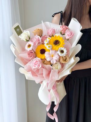 A girl wearing black dress is holding a bouquet of Soap Flower for her graduation - prepared by hug and heart florist subang jaya.