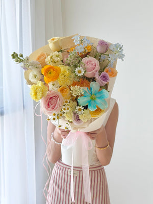 Fresh mixed flower bouquet with blue tulip, buttercup roses and pink roses, ideal for birthday and anniversary gifting in Kuala Lumpur.