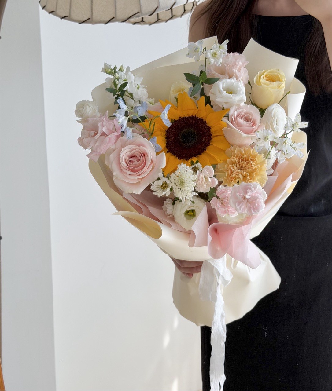Luxury sunflower bouquet with pink roses, carnations, and seasonal flowers beautifully hand-arranged by a local florist at subang jaya.