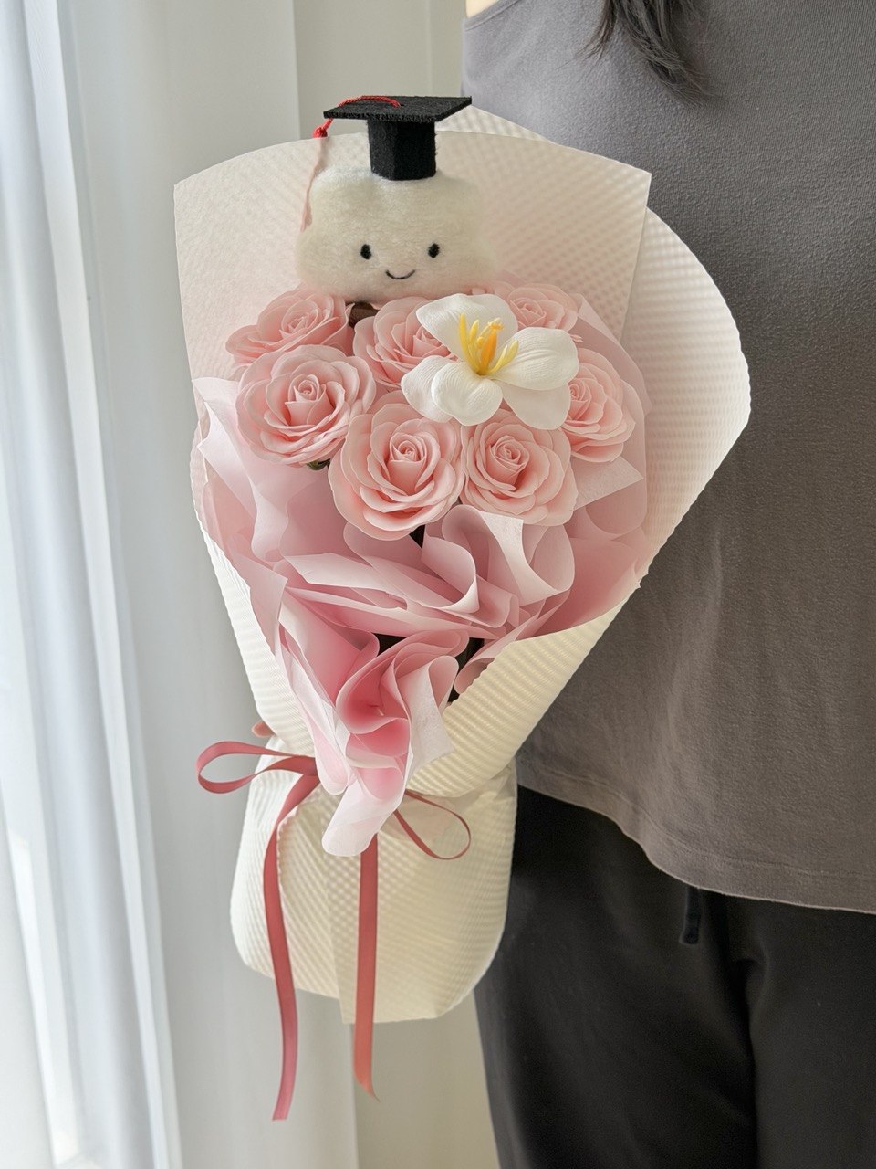 Pink graduation soap flower bouquet with white tulip, cloud bear plush, and graduation cap for convocation gifts in Bukit Jalil and Sunway.